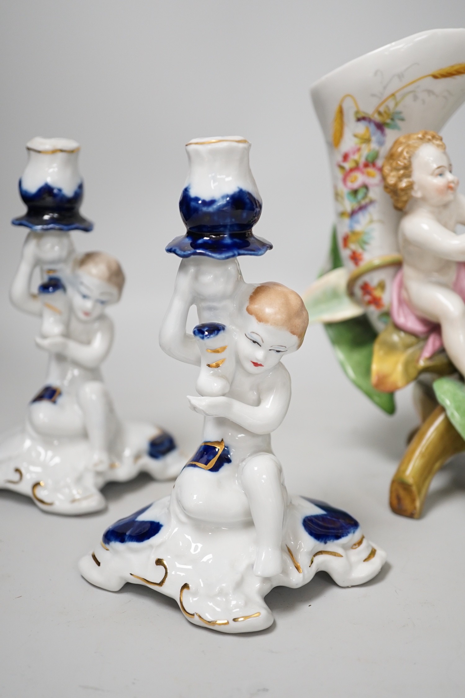 A pair of candlesticks and a figure group flower vase. Tallest 20cm